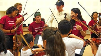 BPYO players working with In Crescendo students BPYO players working with In Crescendo students